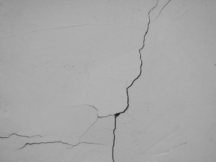 A close-up of a cracked wall, symbolizing the unsettling nature of creepy true stories.