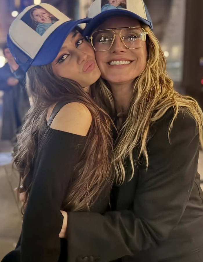 Leni Klum and mom Heidi Klum embrace, both wearing hats with images of Leni Klum, after a lingerie shoot. Leni Klum and mom Heidi Klum embrace, both wearing hats with images of Leni Klum, after a lingerie shoot.