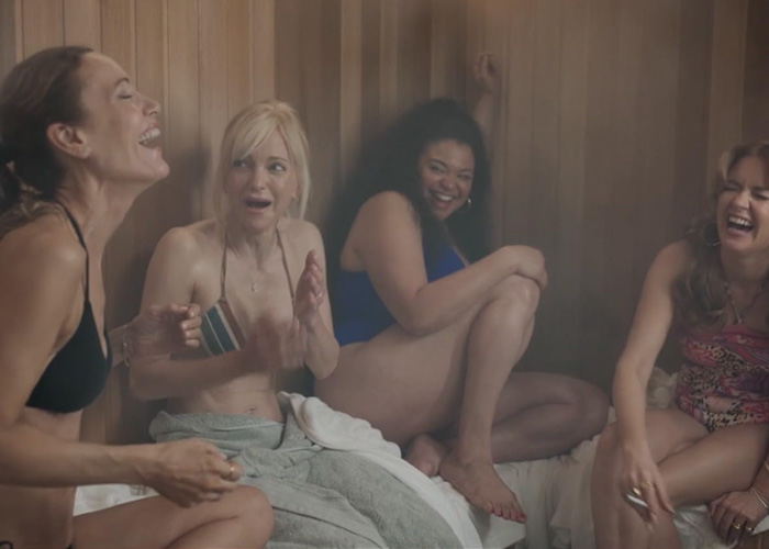 Leslie Mann and Anna Faris with Spa Weekend co-stars in bikinis, laughing in a sauna.