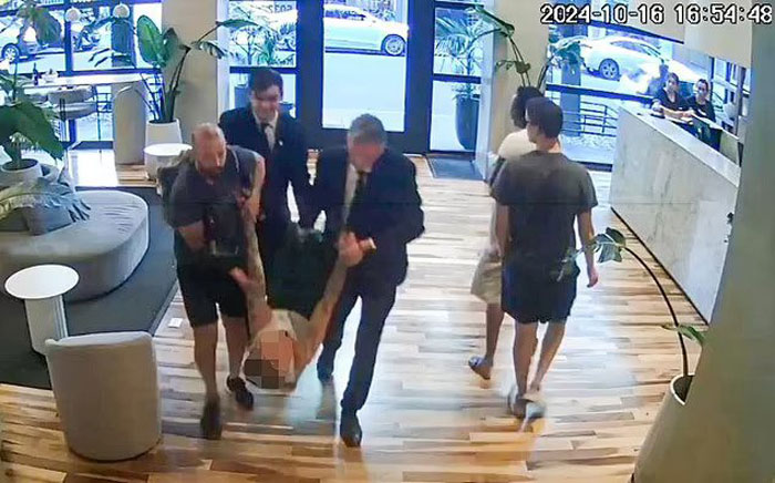 Security carrying a person, hinting at the events of Liam Payne's final hours in police statements. Security carrying a person, hinting at the events of Liam Payne's final hours in police statements.