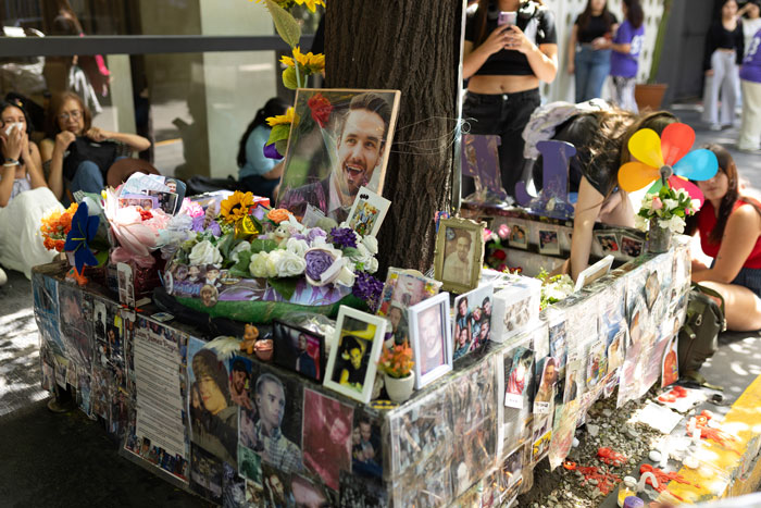 A memorial for Liam Payne with flowers, photos, and personal items, showing fan tributes to his final hours. A memorial for Liam Payne with flowers, photos, and personal items, showing fan tributes to his final hours.