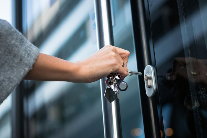 A close-up of a hand inserting a key into a door lock, symbolizing the bro changing home locks. A close-up of a hand inserting a key into a door lock, symbolizing the bro changing home locks.