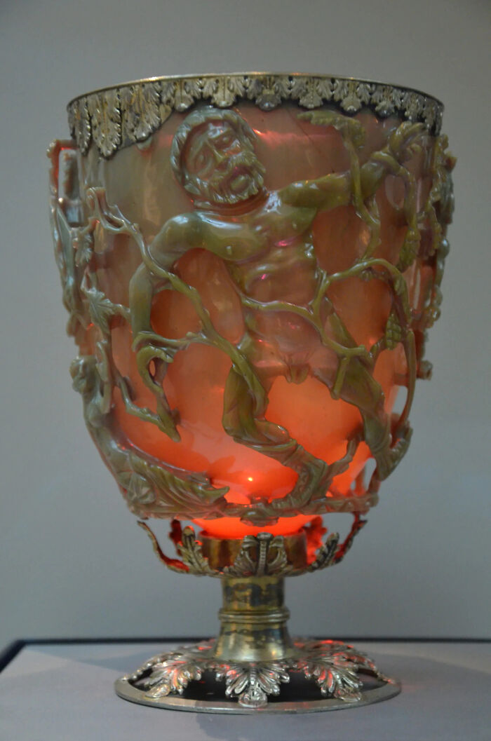 The Lycurgus Cup, a dazzling historical artifact, glows red with intricate carvings of figures, a true survivor.