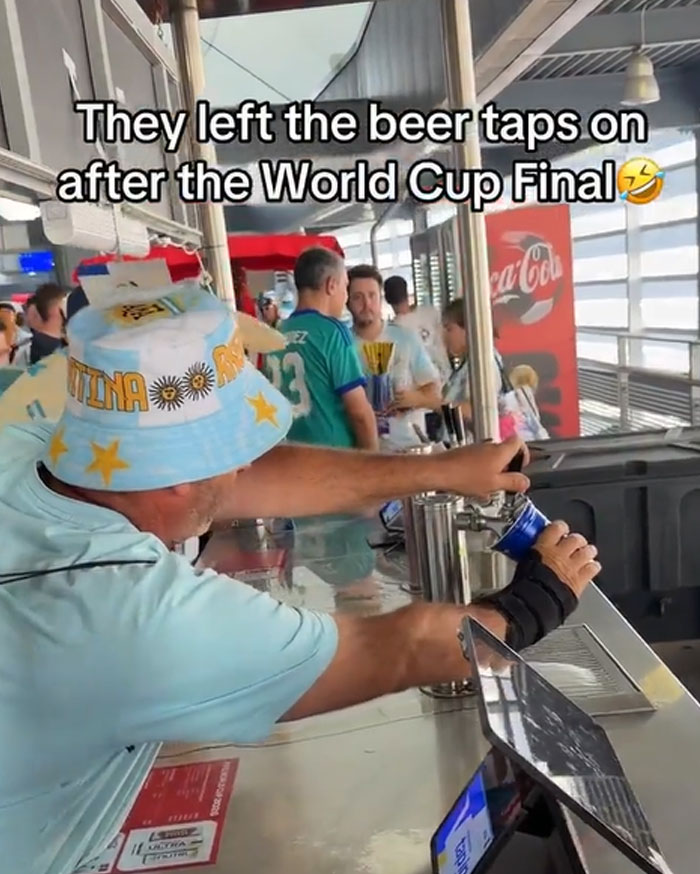 An entitled man in an Argentina hat pouring beer from a tap, one of the entitled folks enjoying free beer.
