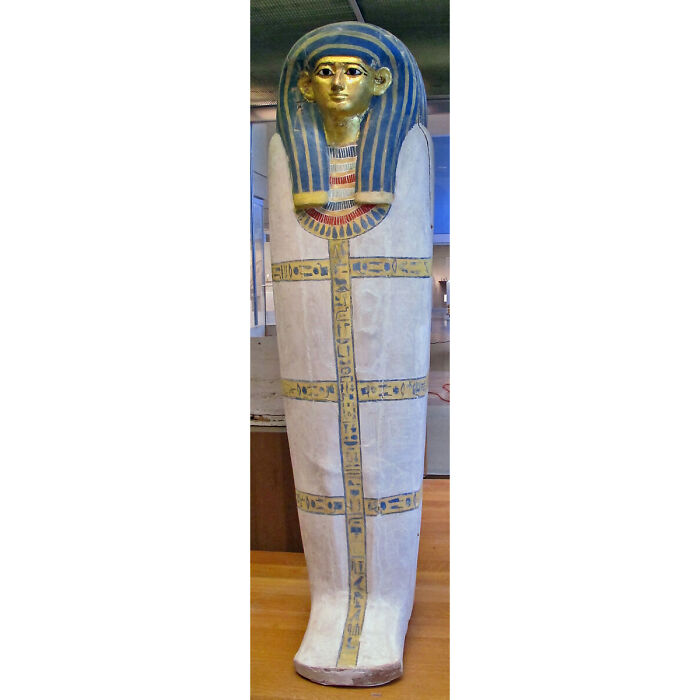 A vibrant Egyptian sarcophagus, a remarkable historical artifact adorned with blue, gold, and white, showcasing survival against the odds.