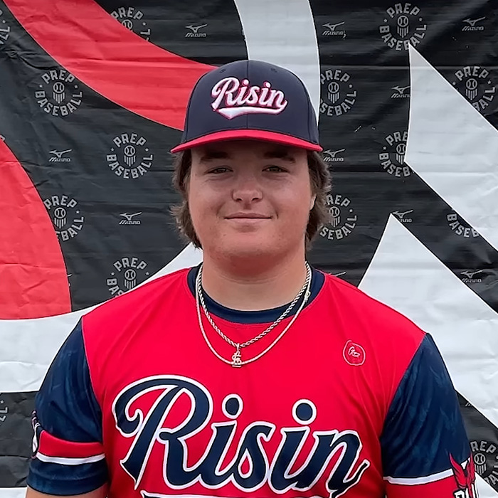 A young male Oklahoma teen in a baseball uniform with a Risin hat, smiling for a photo. Updates on his brutal crimes.