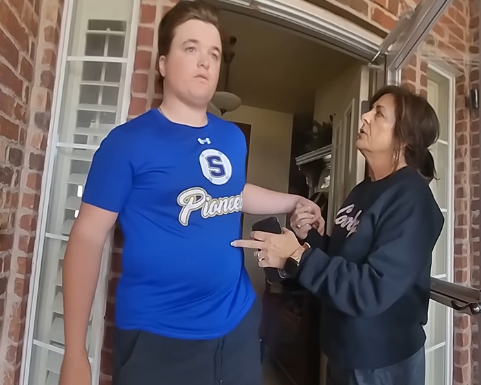 Oklahoma teen in a blue shirt with a woman during a major update in his brutal crimes case.