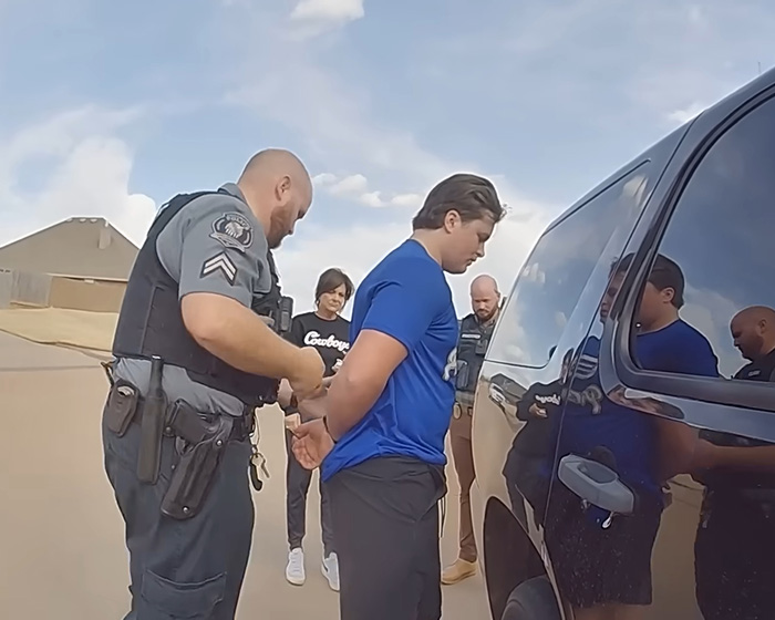 Oklahoma teen being handcuffed by a police officer, facing a prison sentence for brutal crimes.