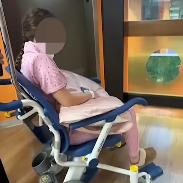 Girlfriend victim of brutal crimes, sitting in a medical chair, central to the Oklahoma teen's case.