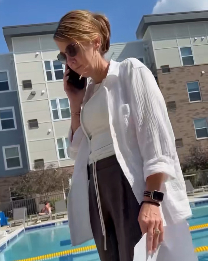 White woman on phone at pool, confronting Black dad with kids. White woman on phone at pool, confronting Black dad with kids.