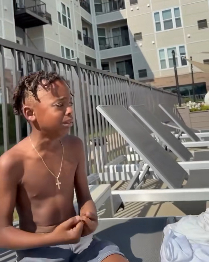 A Black dad with kids looks distressed by the pool, likely during the confrontation. A Black dad with kids looks distressed by the pool, likely during the confrontation.