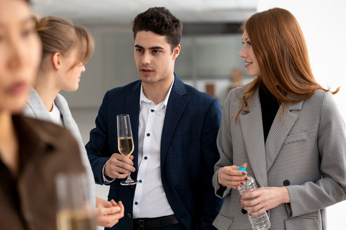 Business people conversing at a celebration, revealing how a man was caught for not showing up to work for 6 years. Business people conversing at a celebration, revealing how a man was caught for not showing up to work for 6 years.