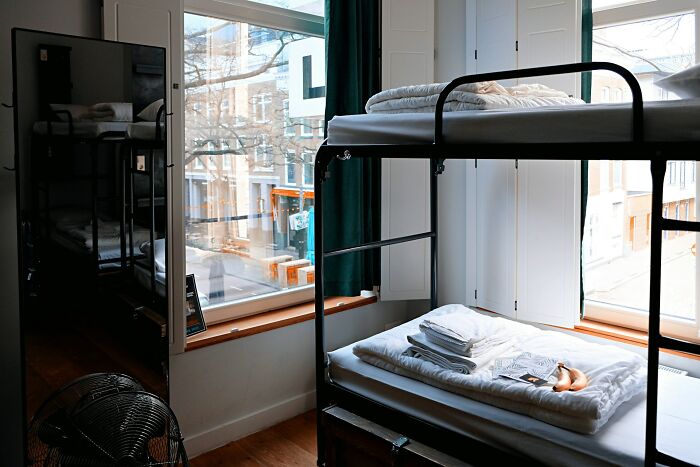 College life: A dorm room with bunk beds, neatly made, symbolizing complete freedom and a new world experience.