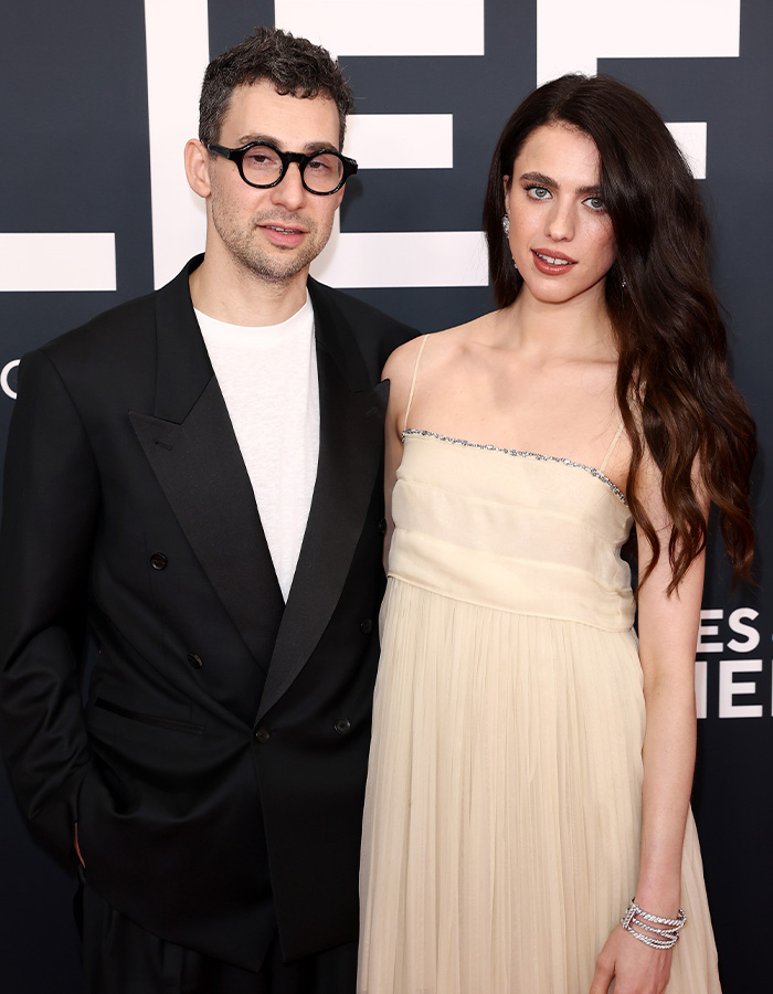Margaret Qualley and Jack Antonoff posing, with Qualley facing fashion scrutiny for her barefoot sandals.