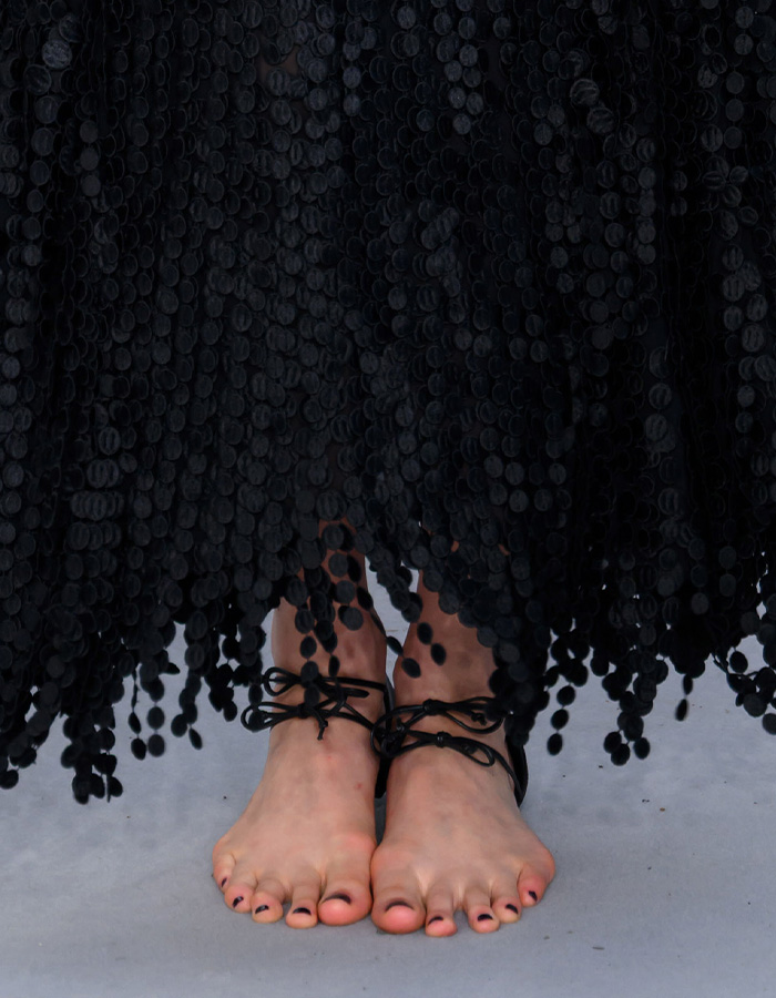 Margaret Qualley's feet wearing barefoot sandals, sparking fashion scrutiny.