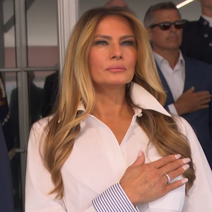 Melania Trump standing with her hand over her heart, observed during the Trump Natalie Harp scandal. Melania Trump standing with her hand over her heart, observed during the Trump Natalie Harp scandal.