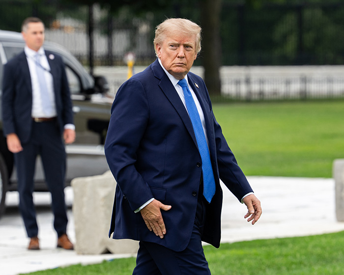 Donald Trump walks across the grass, sparking a frenzy about Melania Trump's reappearance amid an aide scandal. Donald Trump walks across the grass, sparking a frenzy about Melania Trump's reappearance amid an aide scandal.