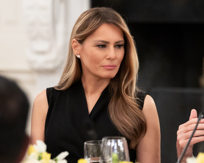 Melania Trump looks pensive at a table, her reappearance sparking frenzy amid the President's aide scandal. Melania Trump looks pensive at a table, her reappearance sparking frenzy amid the President's aide scandal.