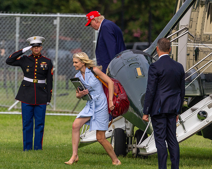 Donald Trump exits a helicopter while an aide, part of the president's aide scandal, descends with a Marine saluting. Donald Trump exits a helicopter while an aide, part of the president's aide scandal, descends with a Marine saluting.