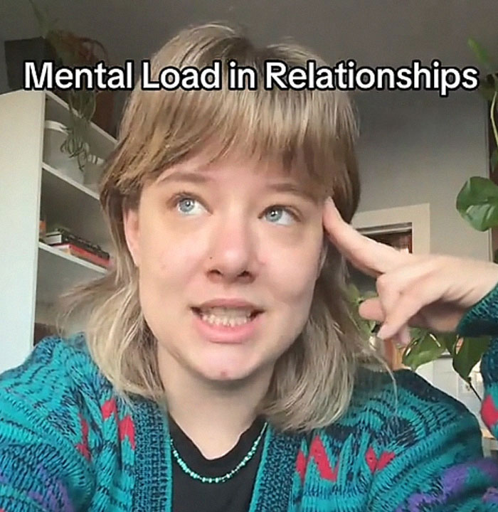 A woman explaining mental load in relationships, gesturing to her head, with the phrase "Mental Load in Relationships" visible. A woman explaining mental load in relationships, gesturing to her head, with the phrase "Mental Load in Relationships" visible.