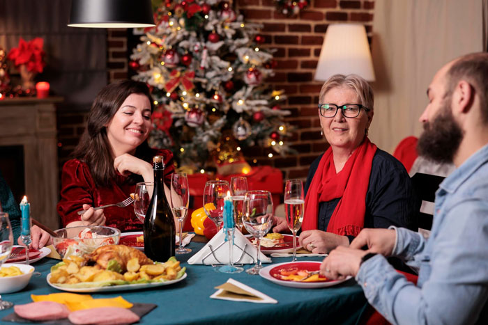 Future grandma at Christmas dinner planning baby's first Christmas without asking parents. Future grandma at Christmas dinner planning baby's first Christmas without asking parents.