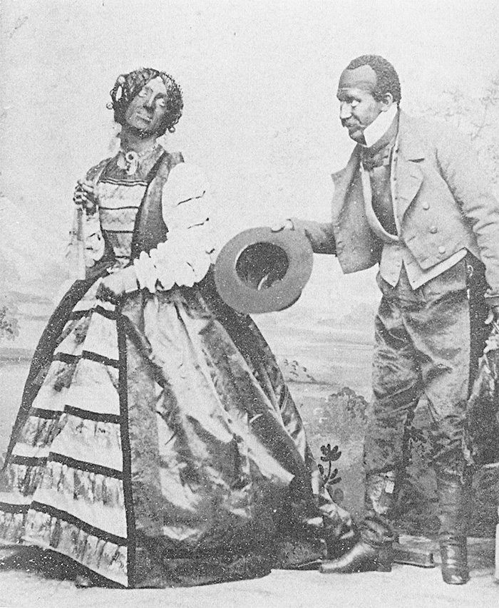 An old photograph depicting two individuals in blackface, highlighting the historical context of racist costume controversies. An old photograph depicting two individuals in blackface, highlighting the historical context of racist costume controversies.