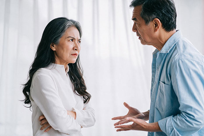 A mom looking upset as her new bf argues, demonstrating his entitled rules for her son. A mom looking upset as her new bf argues, demonstrating his entitled rules for her son.
