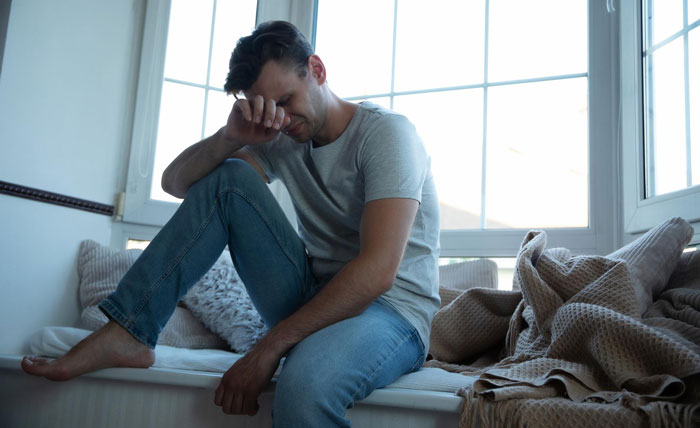 A man sits sadly by a window, in debt after his cheater wife ditched him, while his selfish mom doesn't care. A man sits sadly by a window, in debt after his cheater wife ditched him, while his selfish mom doesn't care.