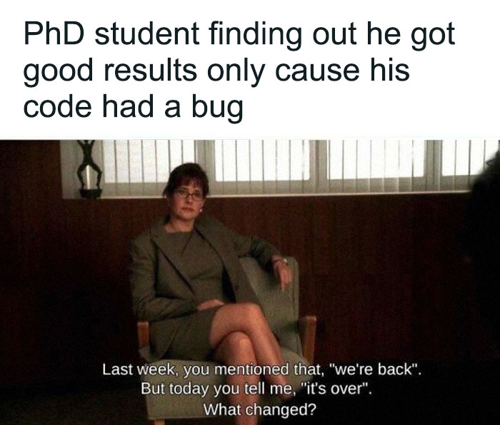 A woman in a suit, from a movie scene, represents a PhD student learning about a code bug. A relatable PhD meme.