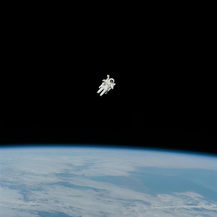 An astronaut floating in space above Earth, illustrating cool scientific facts about space exploration.