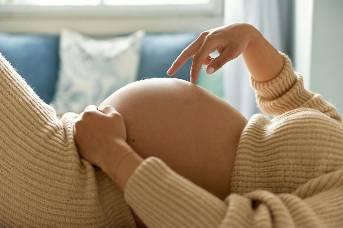 A pregnant woman touches her belly. Doctors reveal the diagnoses that were the hardest to deliver.