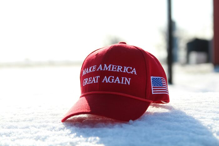 A red MAGA hat in the snow, representing a moment where a person walked out without their therapist.