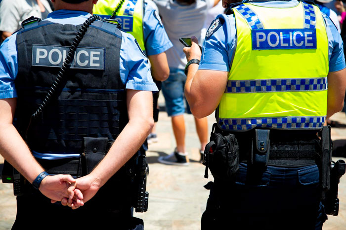 Police officers with vests, helping new parents with a rude neighbor's illegal antenna. Police officers with vests, helping new parents with a rude neighbor's illegal antenna.