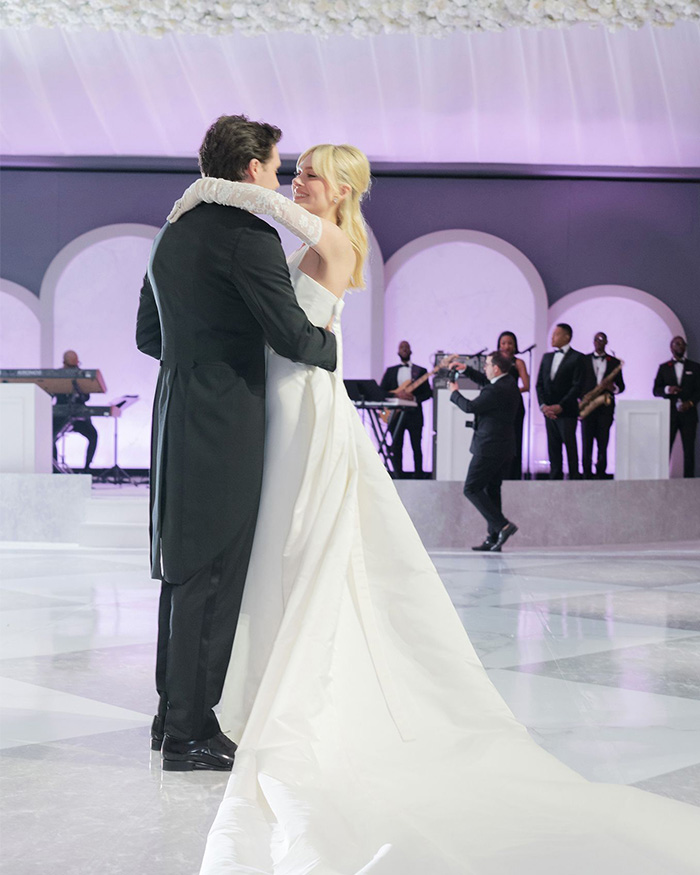 A couple dancing at their wedding, the bride in a flowing white gown and the groom in a tuxedo, on a dance floor. A couple dancing at their wedding, the bride in a flowing white gown and the groom in a tuxedo, on a dance floor.