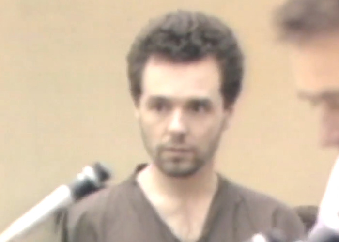 A nurse's aide during a court appearance, looking at the camera. A nurse's aide during a court appearance, looking at the camera.