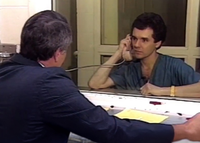 A nurse's aide suspected of horrific crimes talks on a prison phone. A nurse's aide suspected of horrific crimes talks on a prison phone.