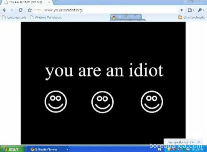 A webpage from the Old Internet era, displaying the text You Are An Idiot with three smiley faces on a black background.