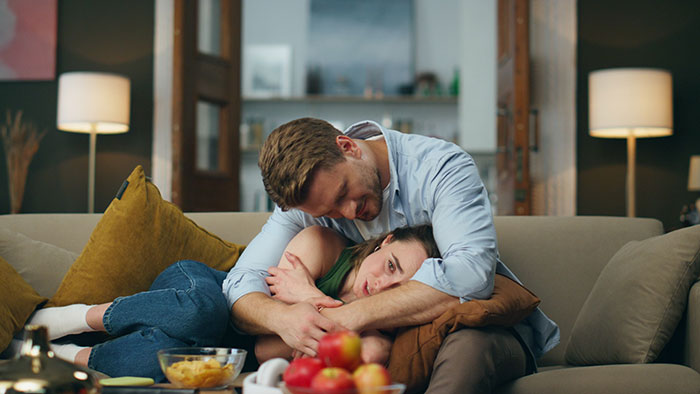 A woman seeks comfort from her partner, distressed about her toxic BIL's attendance at her wedding. A woman seeks comfort from her partner, distressed about her toxic BIL's attendance at her wedding.