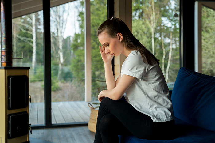 A thoughtful GF on a couch, dealing with her BF having female friends. A coworker is taking up too much of his time.