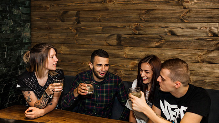 A group of friends enjoying drinks, illustrating the topic of female friends and time management with a boyfriend.