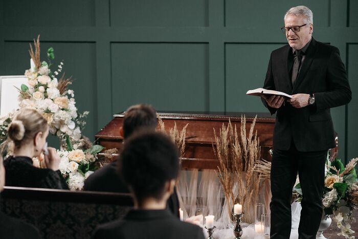 A man speaking at a funeral, showing the painful stories of those raised by narcissists.
