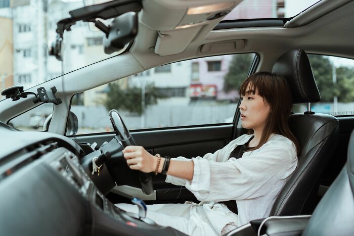 A woman driving, illustrating the silent struggles of being raised by narcissists.