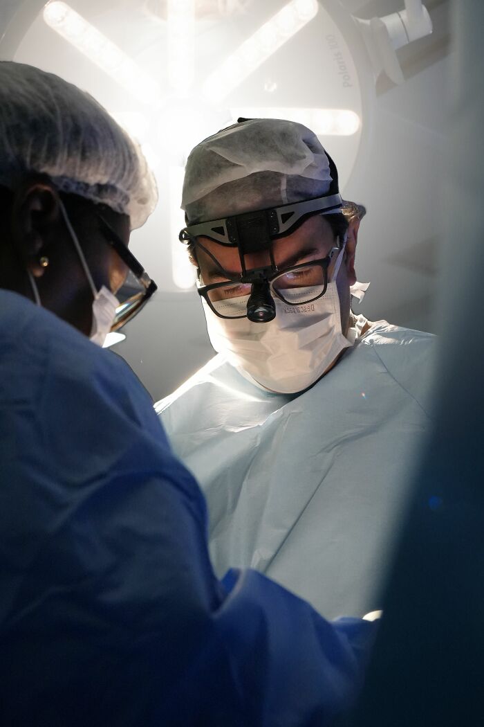 Surgeons perform an operation, highlighting the theme of healing from being raised by narcissists.