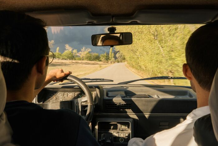 Two men in a car on a road trip, contemplating the painful stories of those raised by narcissists.