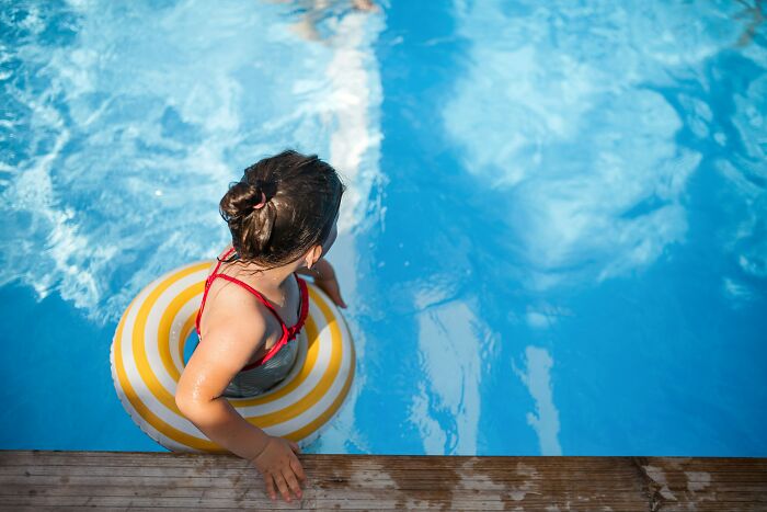 A young girl in a swimming pool with a yellow and white float. This image evokes scariest things people witness.