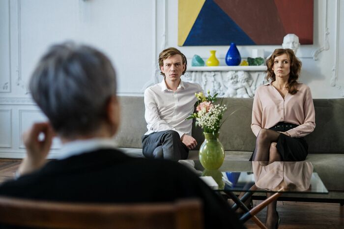 A couple sits on a couch across from a therapist, discussing gender roles and toxic femininity.