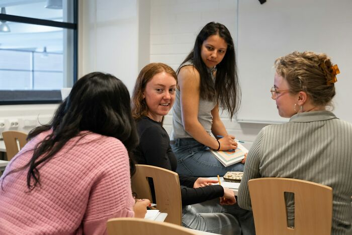 Diverse group of young women engaging in discussion, reflecting on controversial examples of toxic femininity and gender roles.
