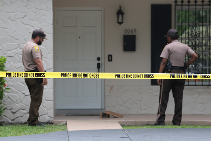 Police tape across a house, hinting at Perez Hilton's heartbreaking question and his family's answer from a hospital bed.