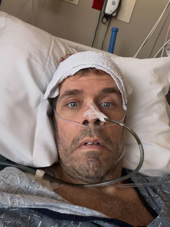 Perez Hilton in a hospital bed with a towel on his head and a nasal tube, looking at the camera, part of his crisis. Perez Hilton in a hospital bed with a towel on his head and a nasal tube, looking at the camera, part of his crisis.