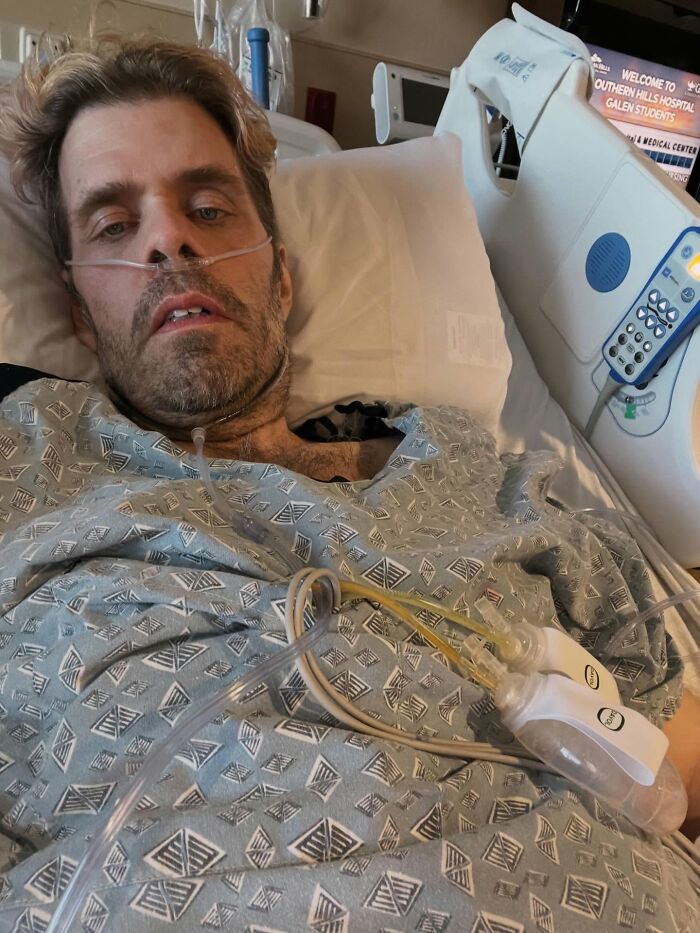 Perez Hilton in a hospital bed, looking unwell, with medical tubes and equipment for his crisis. Perez Hilton in a hospital bed, looking unwell, with medical tubes and equipment for his crisis.